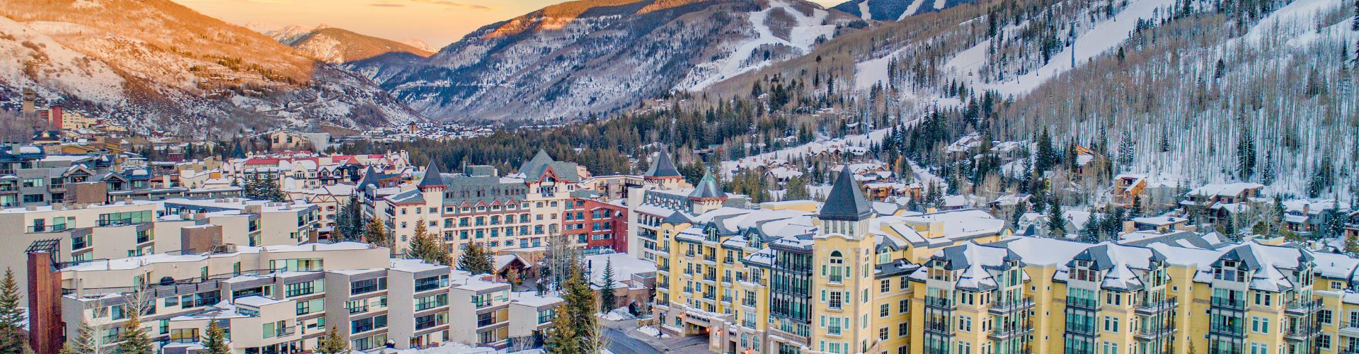 panoramic view of Vail, CO nestled at the base of the mountains