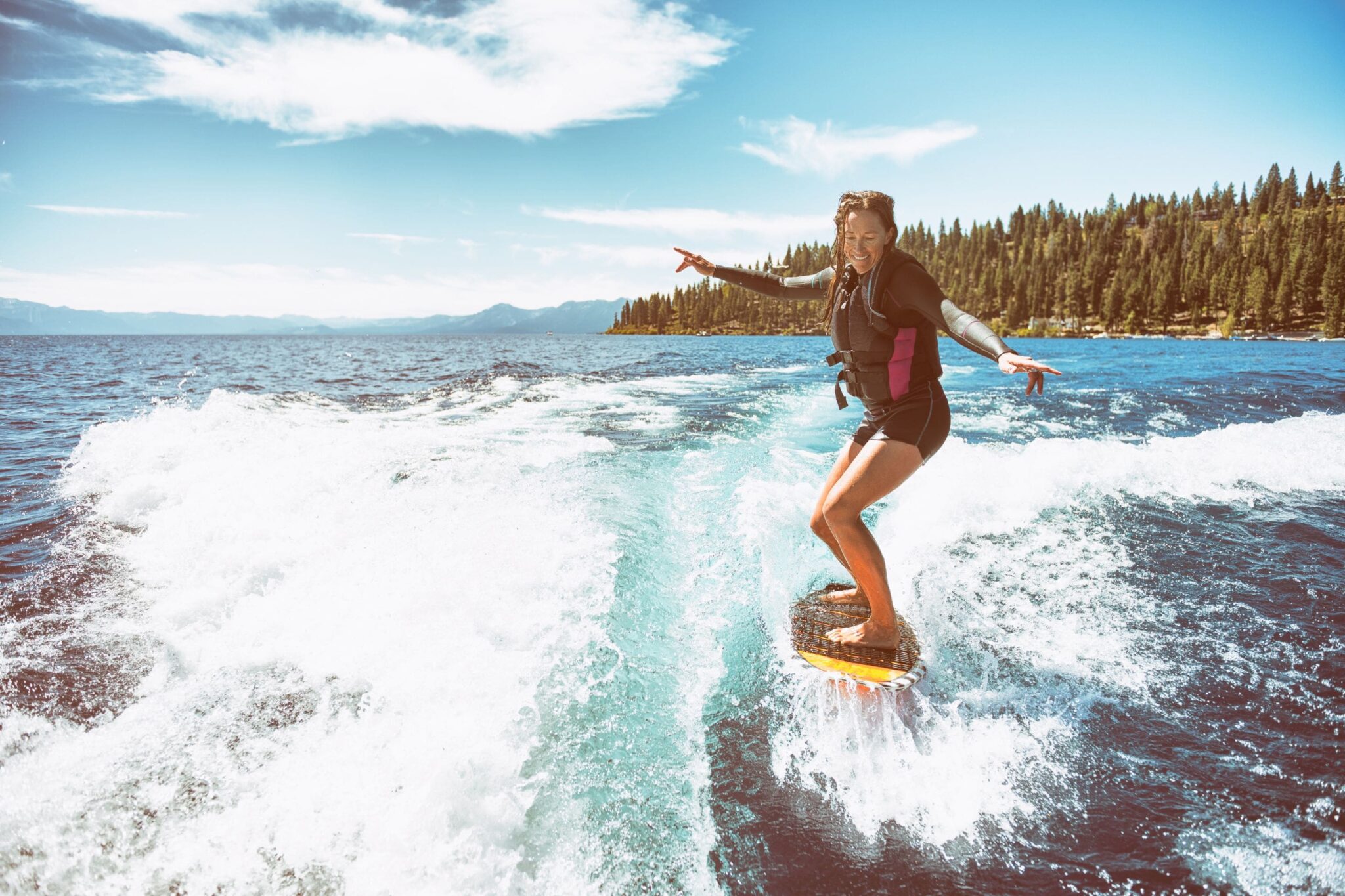 woman wake boarding behind a boat on Lake Tahoe
