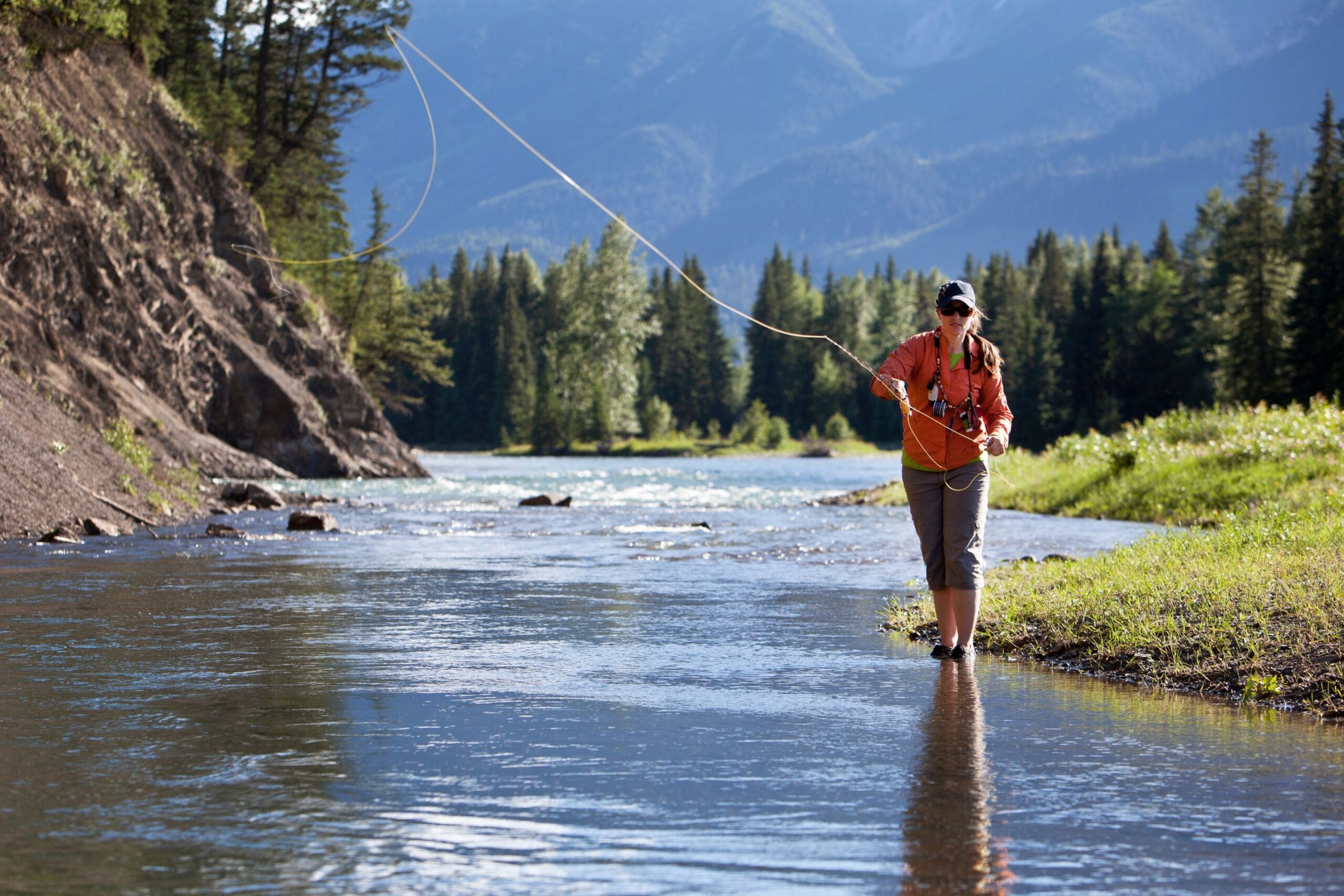 woman casting a line fly fishing