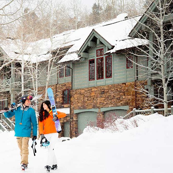 Couple walking with skis in Beaver Creek