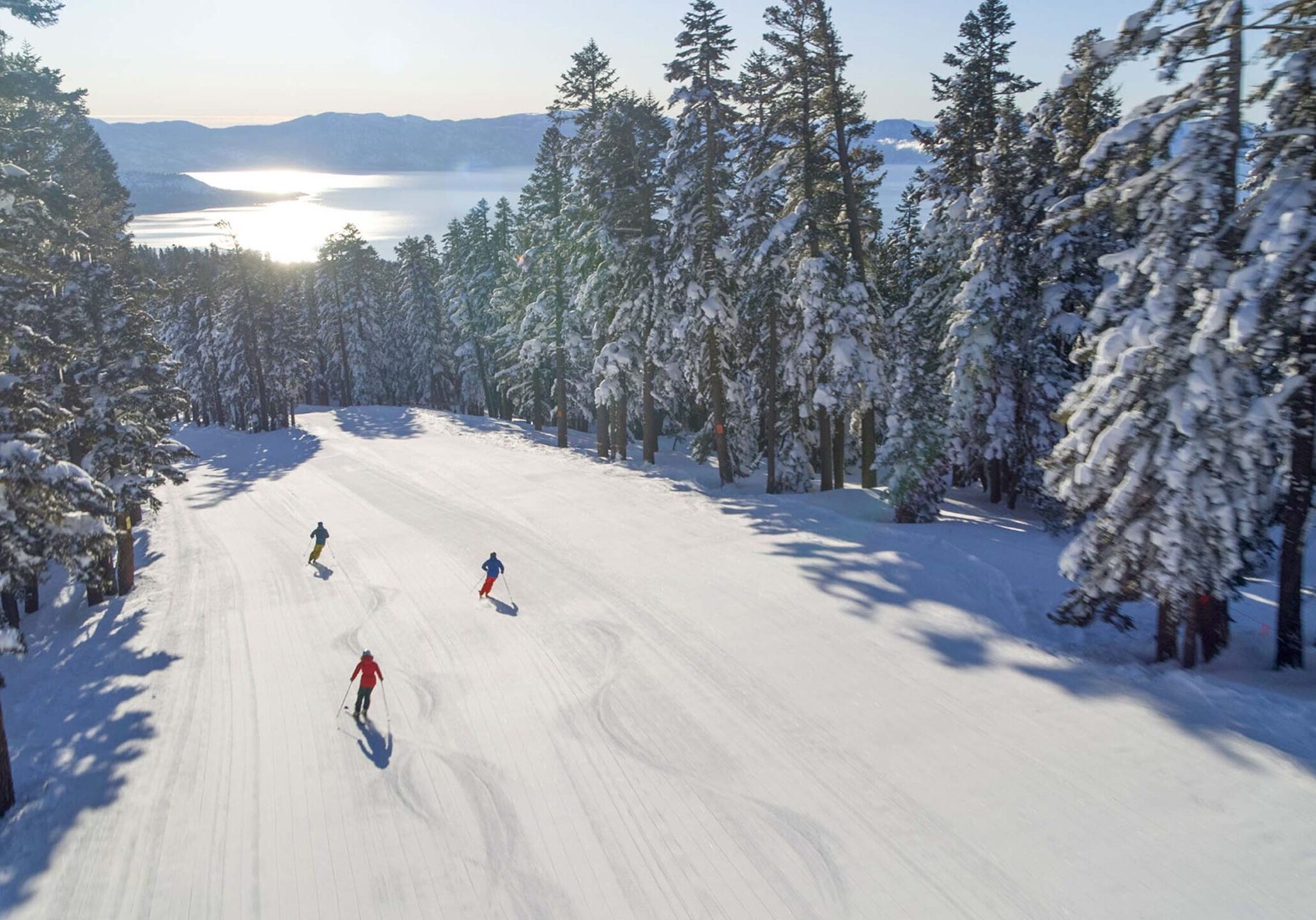 Aerial Photo of Three People Skiing down East Ridge at Northstar